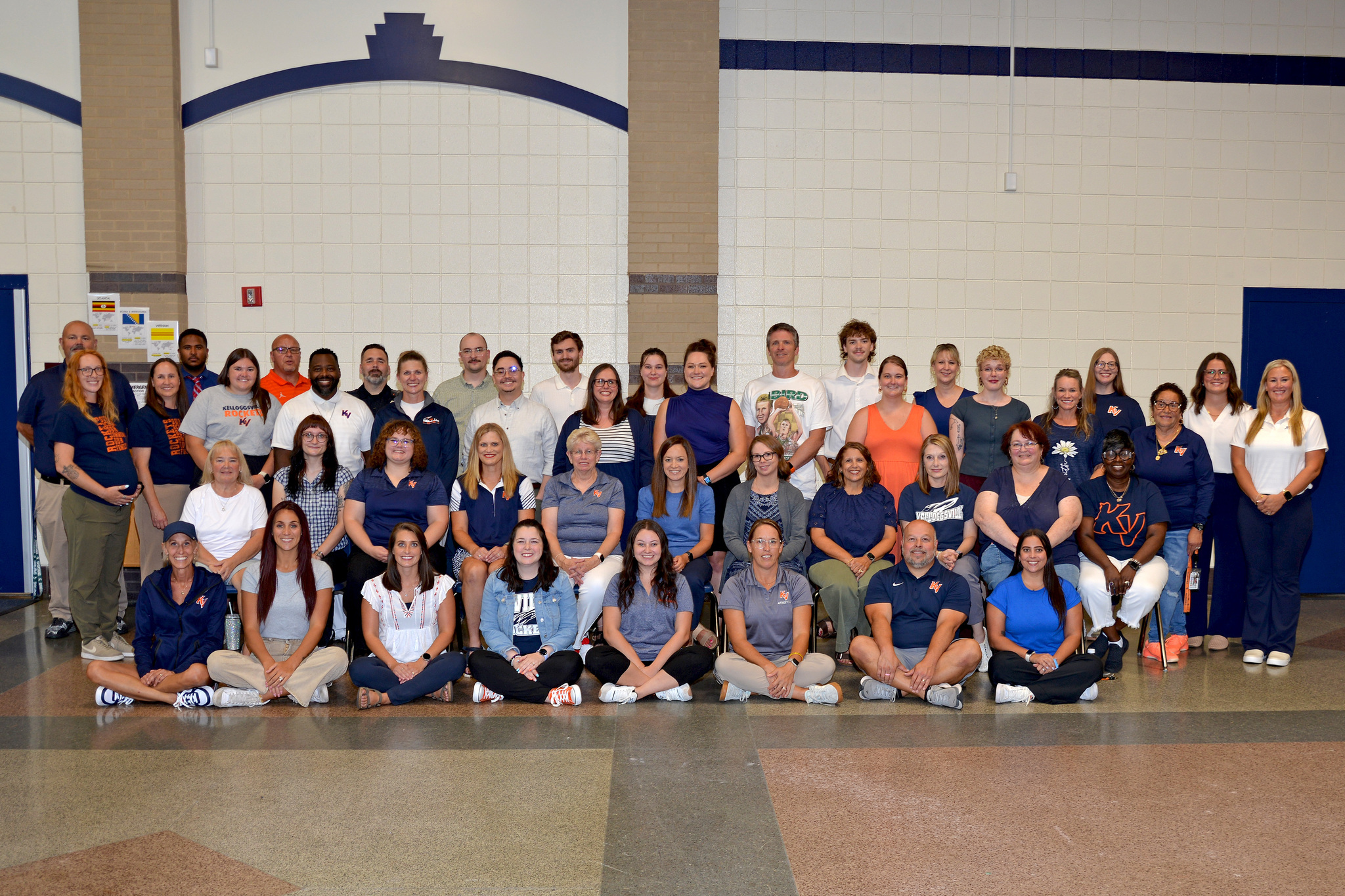 KMS staff in front of a brick wall.