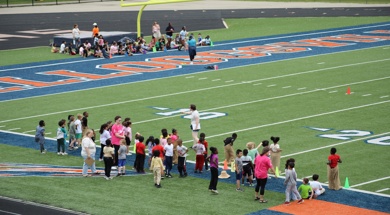 Students scattered on a football field.