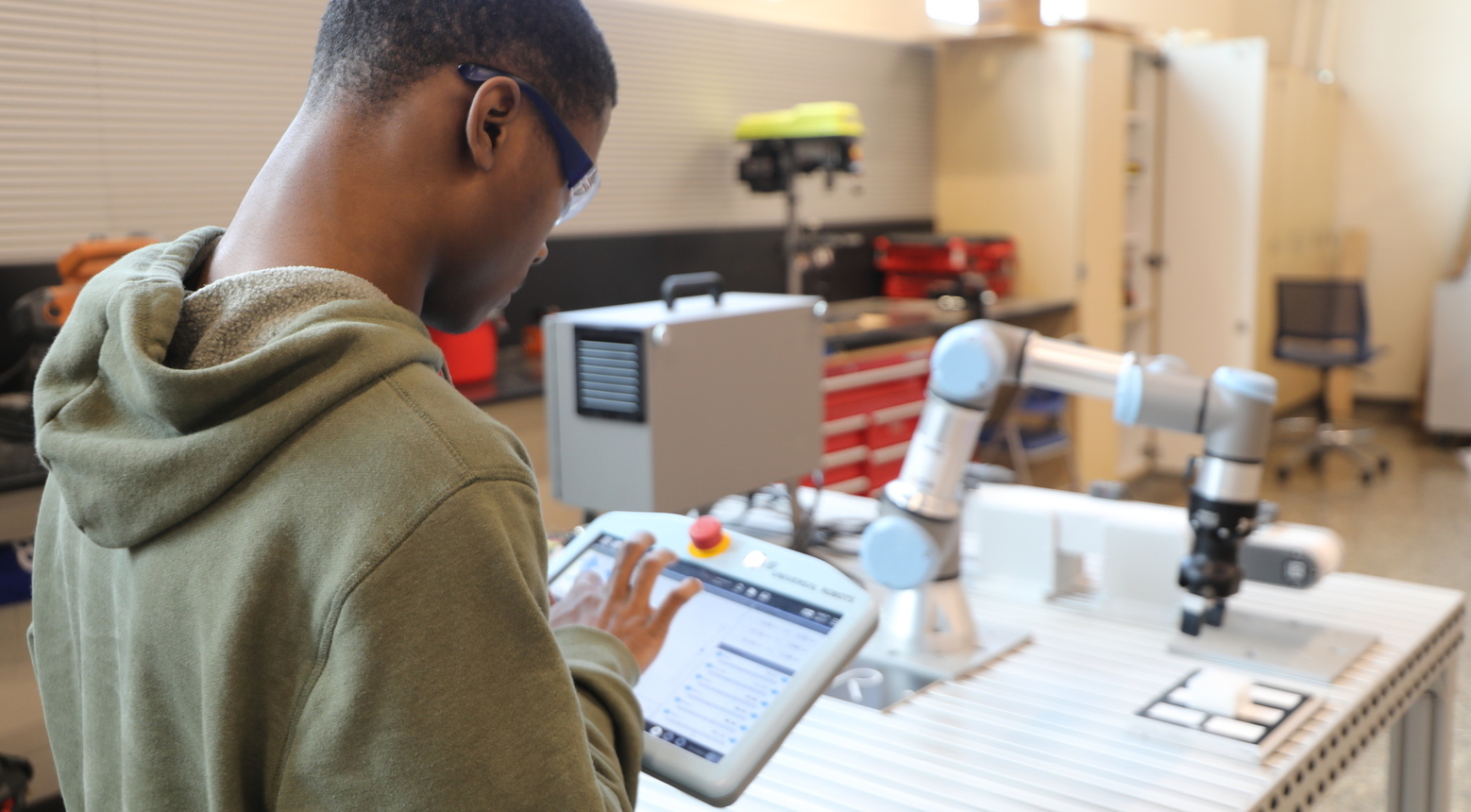 Student working with a robotic arm in our STEM program.
